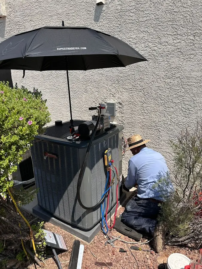 HVAC technician performing outdoor AC maintenance in The Village of Indian Hill