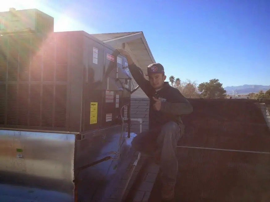 HVAC technician performing Heat Pump Repair on a rooftop unit in The Village of Indian Hill